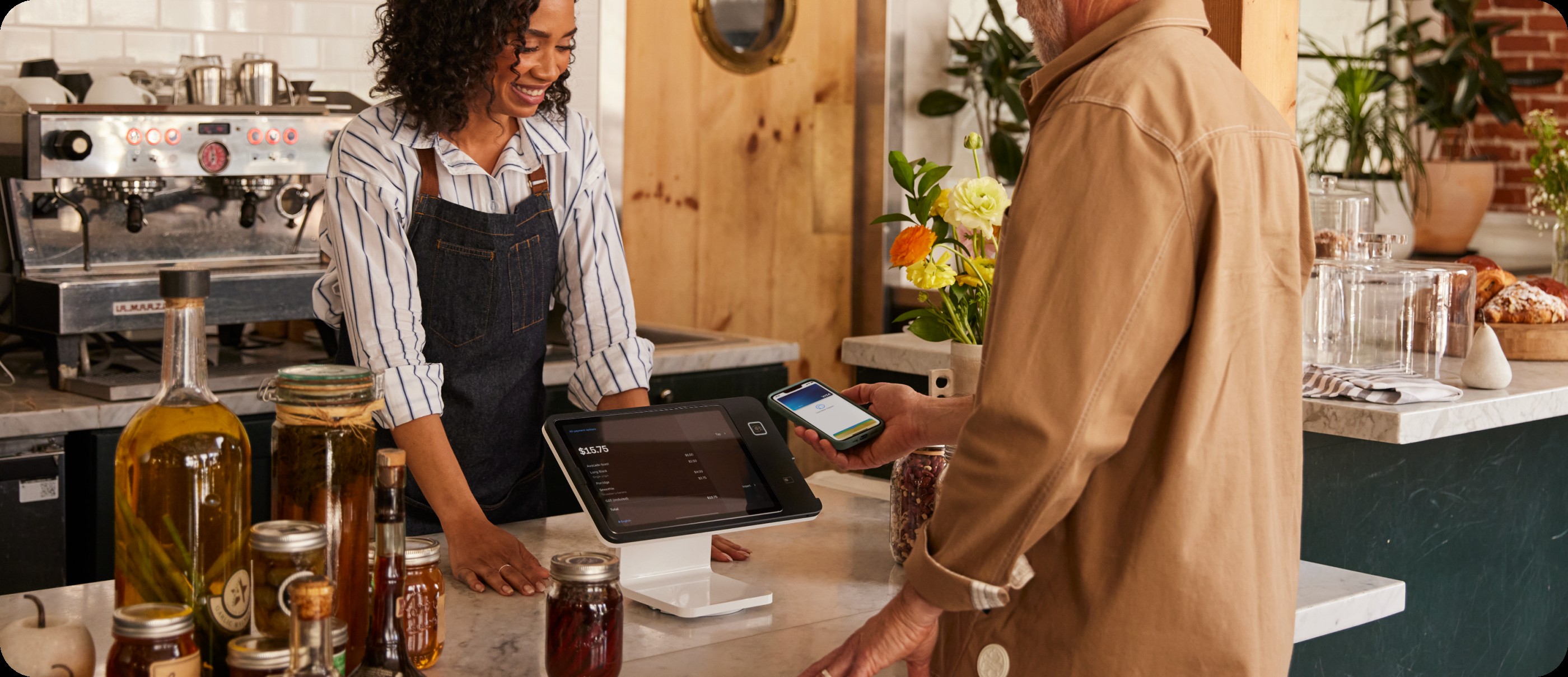 Customer paying at a café counter with Square Stand